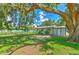 A lovely backyard, showcasing a spacious lawn, large tree, and serene outdoor space at 475 W Ethelene St, Bartow, FL 33830