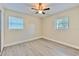 Comfortable bedroom with new floors, two windows, and a ceiling fan at 475 W Ethelene St, Bartow, FL 33830