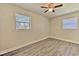 Bright bedroom features stylish gray wood flooring and modern ceiling fan at 475 W Ethelene St, Bartow, FL 33830