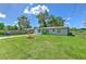 Home's front exterior with a large grassy yard at 475 W Ethelene St, Bartow, FL 33830
