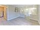 Inviting living room boasts new gray wood flooring, and updated lighting in a light neutral color palette at 475 W Ethelene St, Bartow, FL 33830