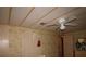 Bedroom needs repair with ceiling fan, panel walls, damage to the ceiling and walls at 515 Cassandra Ln, Lakeland, FL 33809