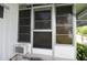 Home exterior featuring screened windows and an air conditioning unit at 515 Cassandra Ln, Lakeland, FL 33809