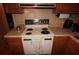 A kitchen with an electric range and wooden cabinets at 515 Cassandra Ln, Lakeland, FL 33809