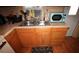 Kitchen featuring a stainless steel sink with wooden cabinets and a blue microwave at 515 Cassandra Ln, Lakeland, FL 33809
