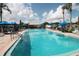 Community outdoor pool with clear blue water surrounded by lounge chairs and palm trees at 515 Cassandra Ln, Lakeland, FL 33809