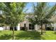 A manicured backyard with healthy lawn and a pair of young trees at 1143 Presidential Ln, Apopka, FL 32703