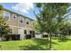 Home's backyard with a well-maintained lawn, privacy fence, and manicured greenery at 1143 Presidential Ln, Apopka, FL 32703
