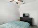 Bedroom has plank floors, a ceiling fan and includes a dresser and television at 1143 Presidential Ln, Apopka, FL 32703