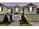 Charming townhomes with well-maintained landscaping, brick-paved driveways, and attached two-car garages at 1143 Presidential Ln, Apopka, FL 32703