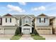 Attractive townhome showcasing a two-car garage, craftsman-style windows, and an inviting entrance at 1143 Presidential Ln, Apopka, FL 32703