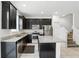 Kitchen with stainless steel appliances, dark cabinetry, granite countertops, and a center island at 1143 Presidential Ln, Apopka, FL 32703