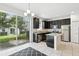 Bright kitchen featuring stainless steel appliances, dark cabinetry, and granite countertops at 1143 Presidential Ln, Apopka, FL 32703