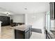 Modern kitchen featuring white walls, granite countertops, and a black kitchen island at 1143 Presidential Ln, Apopka, FL 32703