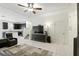 Living room with neutral walls, a ceiling fan, tile floors, and an adjacent kitchen at 1143 Presidential Ln, Apopka, FL 32703