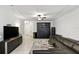 Expansive living room featuring tile flooring, a leather sectional, and modern entertainment center at 1143 Presidential Ln, Apopka, FL 32703
