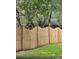 Fenced backyard featuring lush greenery and mature trees at 204 Madison St, Minneola, FL 34715