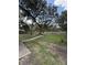 A well maintained backyard with a play structure and a seating area at 204 Madison St, Minneola, FL 34715