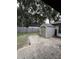 Exterior shot of backyard shed storage with concrete foundation and patio at 204 Madison St, Minneola, FL 34715