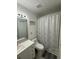 Bathroom featuring a shower with a decorative curtain at 204 Madison St, Minneola, FL 34715