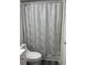 Cozy bathroom featuring a tub with a modern pattern shower curtain and a standard toilet at 204 Madison St, Minneola, FL 34715