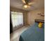 Sunlit bedroom with a ceiling fan and a comfortable bed, creating a peaceful retreat at 204 Madison St, Minneola, FL 34715