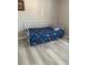 Bedroom with twin daybed frame, laminate floors and bright sports-themed blue comforter at 204 Madison St, Minneola, FL 34715