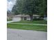 Charming single story home with an attached garage and mature trees in the front yard at 204 Madison St, Minneola, FL 34715