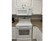 Bright kitchen features white cabinets, granite countertops, and modern appliances at 204 Madison St, Minneola, FL 34715