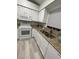 Kitchen featuring granite countertops, stainless steel sink, and white appliances at 204 Madison St, Minneola, FL 34715
