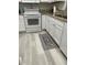 Bright kitchen features white cabinets, granite countertops, and a stylish floor mat at 204 Madison St, Minneola, FL 34715