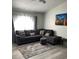 Cozy living room with gray sectional sofa, decorative pillows, and a patterned rug at 204 Madison St, Minneola, FL 34715
