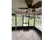 Enclosed back patio offering a serene view of the fenced backyard at 204 Madison St, Minneola, FL 34715