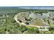 Aerial view of condo community showing proximity to a lake, trees, and surrounding natural beauty at 4711 Club Cir, Lakeshore, FL 33854