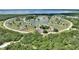 Condo aerial view of complex nestled in a circular layout around a beautiful central lake at 4711 Club Cir, Lakeshore, FL 33854