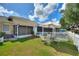 Spacious backyard features a seating area with a striped umbrella and a view at 4711 Club Cir, Lakeshore, FL 33854