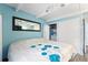 Light filled bedroom with white closet doors and view of the backyard at 4711 Club Cir, Lakeshore, FL 33854