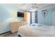 Cozy bedroom with blue walls, light wood dresser, and ceiling fan at 4711 Club Cir, Lakeshore, FL 33854