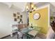 Elegant dining area with a glass table, chandelier, and decorative wall art at 4711 Club Cir, Lakeshore, FL 33854