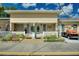 Charming townhome with a well-maintained lawn, a white picket fence, and a private golf cart at 4711 Club Cir, Lakeshore, FL 33854