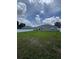 Spacious backyard enclosed by a white fence, offering privacy and a large grassy area at 10090 Se 67Th Ter, Belleview, FL 34420