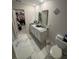 Bright bathroom featuring a double vanity with granite countertop and a large walk-in closet at 10090 Se 67Th Ter, Belleview, FL 34420