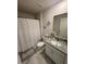 Cozy bathroom with a shower, vanity with granite countertop, and decor that enhances the relaxing atmosphere at 10090 Se 67Th Ter, Belleview, FL 34420