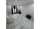 Bright bedroom featuring modern decor, marble floors, and ample space, creating a comfortable and stylish retreat at 10090 Se 67Th Ter, Belleview, FL 34420