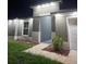 A well-lit home showcasing a walkway and manicured garden area at the front entrance at 10090 Se 67Th Ter, Belleview, FL 34420