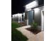 Single-Gathering home exterior showcases modern lighting and a manicured garden area at 10090 Se 67Th Ter, Belleview, FL 34420