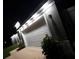 Well-lit attached two-car garage with modern exterior lighting at 10090 Se 67Th Ter, Belleview, FL 34420