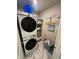 Efficient laundry room with marble floors, modern washer and dryer units, and storage shelves for convenience at 10090 Se 67Th Ter, Belleview, FL 34420