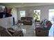 Living room featuring contemporary furnishings and views from large windows at 10090 Se 67Th Ter, Belleview, FL 34420