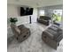 Spacious living room with marble floors, comfortable seating, and ample natural light at 10090 Se 67Th Ter, Belleview, FL 34420